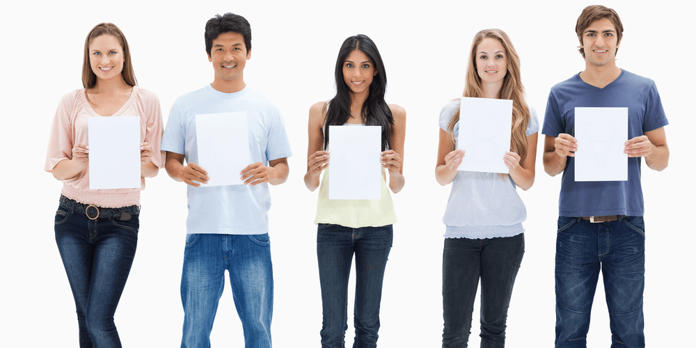 People in jeans holding five signs against white background 1000x500
